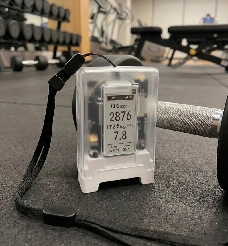 Portable air quality monitor beside gym equipment